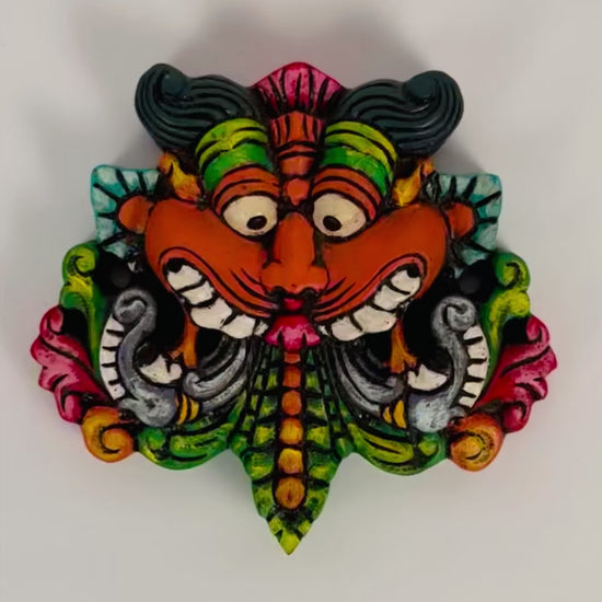 Hand-carved and hand-painted Yaali face wooden wall mount decor